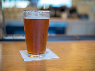 Beer sitting on a table on a bar counter
