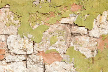 Texture of a stone wall with peeling old paint