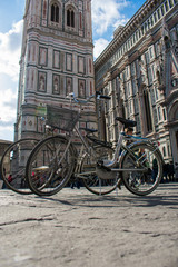 Naklejka na ściany i meble Florence, Tuscany / Italy, - March 8, 2018. Bicycle Parking in Piazza Duomo, opposite the bell tower of the Cathedral