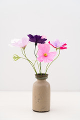Crepe paper cosmos flower bouquet in a ceramic vase