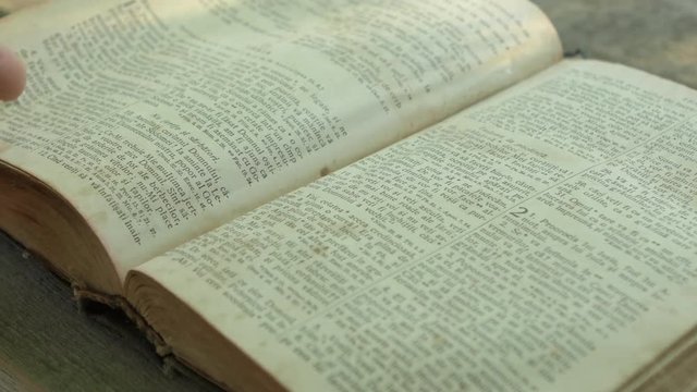 Hand turning the page of the Bible