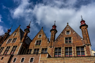 Obraz premium Rooftop with cross and spire on the houses at Brugge, Belgium, Europe