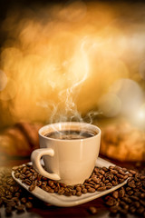 fresh hot coffee laid on the table, roasted coffee beans fried like a decoration on a wooden table, blurred background