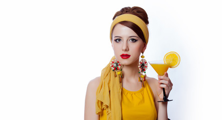 girl in 70s clothes style with tropical cocktail