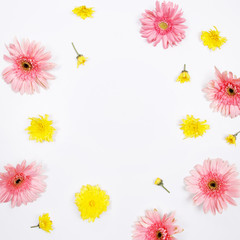 Frame made of pink and yellow flowers on white background. Flat lay, top view. Spring summer background.