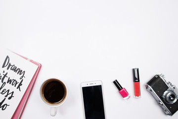 Frame made of vintage camera, coffee cup, smartphone, lipstick and handwritten quote notebook on white background. Flat lay, top view. stylish female blogger concept. Woman travel background.