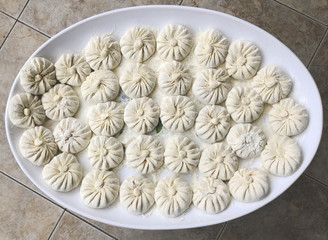 Raw khinkali traditional Georgian dish. Georgian traditional cuisine, domestic khinkali, khinkali according to the old recipe