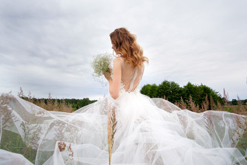 young pretty bride in white wedding dress outdoors, make up and hairstyle