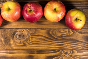 Red apples on wooden table. Top view, copy space