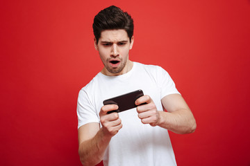 Portrait of an excited young man in white t-shirt
