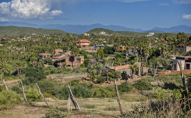 Fototapeta na wymiar The Hills and Homes of the Village of Todos Santos, Mexico as seen from Above with Distant Mountains