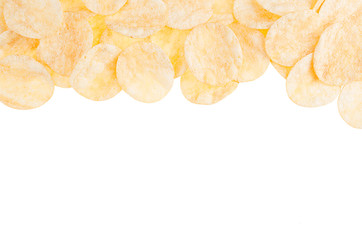 Crunchy potato chips with spices as frame isolated on white background, top view, copy space.