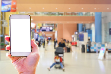 People hand use cellphone at the hall airport background with copy space on screen for using mobile app about activities in the airport or checking flight plan