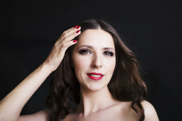 Portrait of beautiful woman in black dress with curly hair - isolated on black background