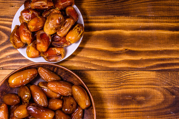 Date fruits on a wooden table. Top view