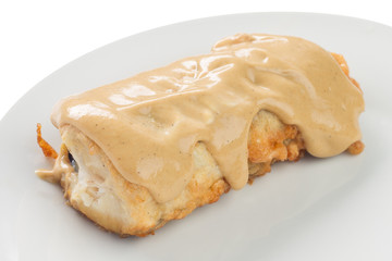 fried fish with white sauce on a plate, white background
