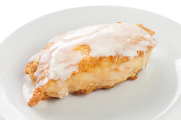 fried fish with sour cream sauce on a plate, white background