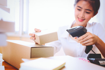 Young asian women holding scanner and scanning barcode with laser at store,Inspection for transport.scan barcodes for sale,online and business concept.