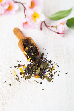 Black tea with flower petals, tea leaves and sakura
