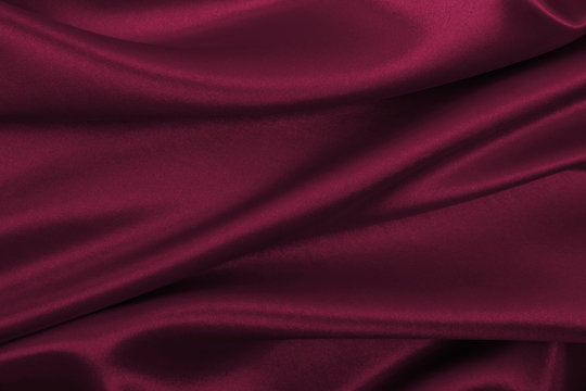 Smooth elegant pink silk or satin luxury cloth texture as abstract background. Luxurious background design