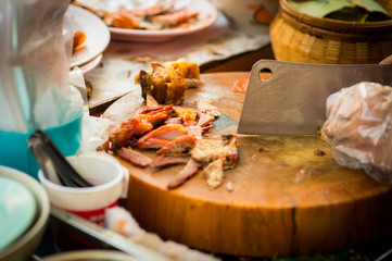 Cut crispy pork on chopping board