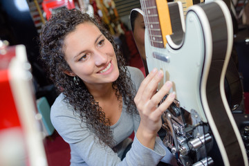 inspecting an electrical guitar