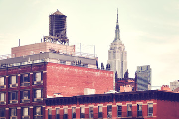 Obraz premium Retro toned picture of an old building with a water tank, one of New York City symbols, USA.
