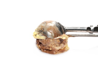 Chocolate and vanilla ice cream ball with metal scoop isolated on white background