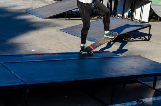 Legs of the skater on skateboard in skatepark