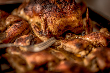 roasted chicken legs on a pan, laid on a wooden table