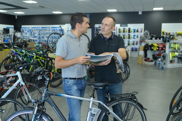 Obraz premium happy smiling man choosing new sport bike