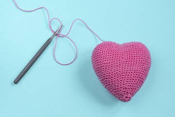 A pink heart. Crochet. Knitted heart.