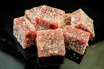 red marmalade on black mirror background