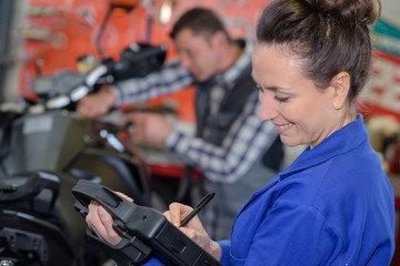 Fototapeta na wymiar happy female motorbike mechanic engineer