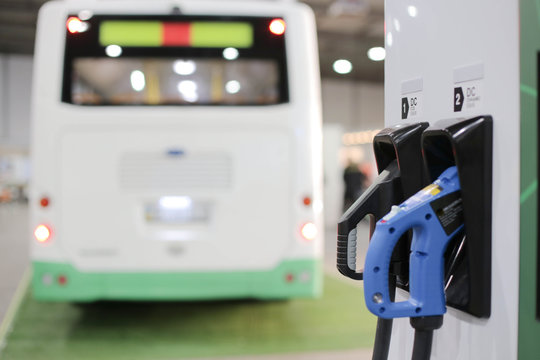 Charging station of an electric car in the background of a bus