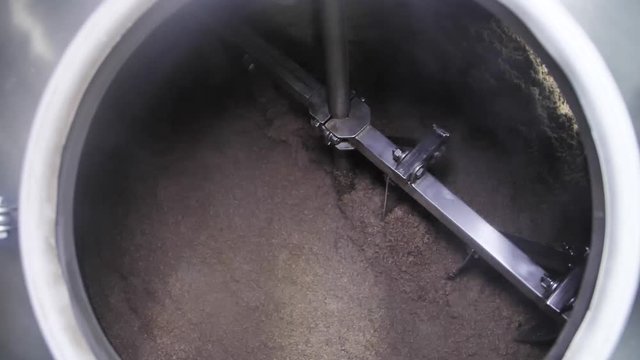 Raw(barley wheat) for beer rotates in big cistern at workshop of brewery factory