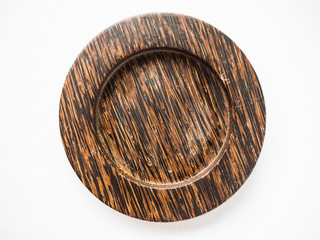 Closeup of texture handmade wooden plate and white background which made from coconut tree.