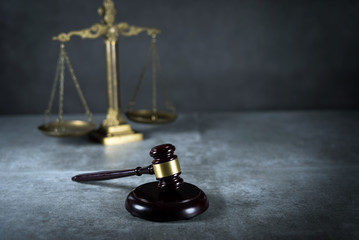 Law and Justice concept. Gray stone background, reflections on the floor, place for typography. Courtroom theme.