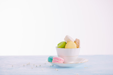 Sweet dessert. Colorful macarons on table in morning.