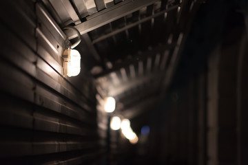 Metal tunnel with lamps. Dark picture.