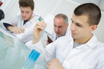 students looking at reaction of chemical liquid in the lab