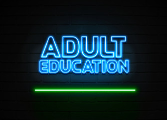 Adult Education neon sign mounted on brick wall.