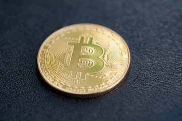 golden bitcoin on black surface