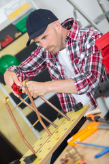 worker connecting copper tubes