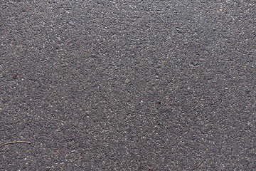 Surface of wet black undamaged asphalt ground