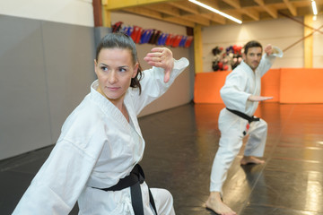 Obraz premium young woman and man karateka training