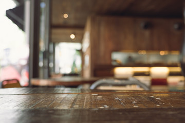 Vintage wooden table with blur bokeh background on cafe