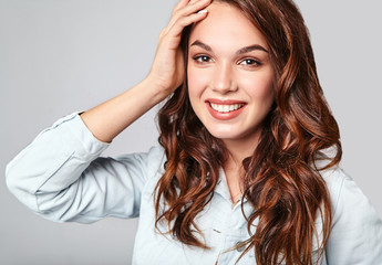 Fototapeta premium Portrait of young stylish laughing girl model in colorful casual summer clothes with natural makeup isolated on gray background. Looking at camera