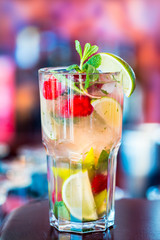 Raspberry Mojito Cocktail with Lime, Mint and Ice in the Bar with Amazing Blurred Background, Free Space for Text, Cold Refreshing Drink
