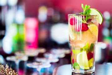 Raspberry Mojito Cocktail with Lime, Mint and Ice in the Bar with Amazing Blurred Background, Free Space for Text, Cold Refreshing Drink